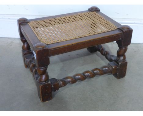 A small oak stool with barleytwist legs and stretchers and caned seat - Height 25 cm x Width 41 cm x Depth 31 cm 