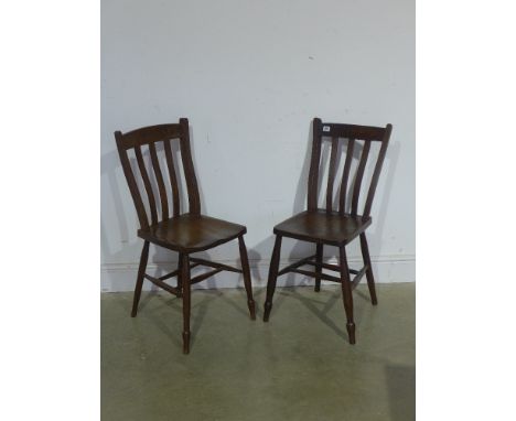A pair of oak and elm stick back chairs