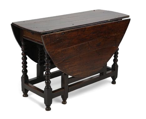 A 17th century and later oak gateleg table, with oval drop leaf top and single frieze drawer, on bobbin turned legs and squar