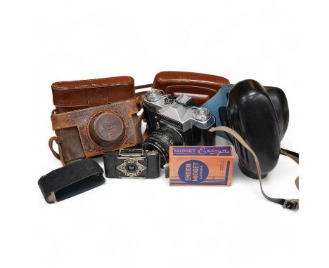 A Leica Model II camera in its original leather case, No. 204618, together with four additional cameras; a Zeiss Ikonta, a Ze