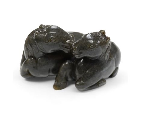 A Chinese carved grey jade group of two recumbent horses, 10cm wide. Condition - good
