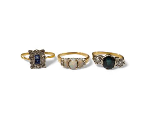 A 10k and three stone opal ring, with diamond set shoulders, an 18ct, sapphire and diamond three stone ring and a 1920's 18ct