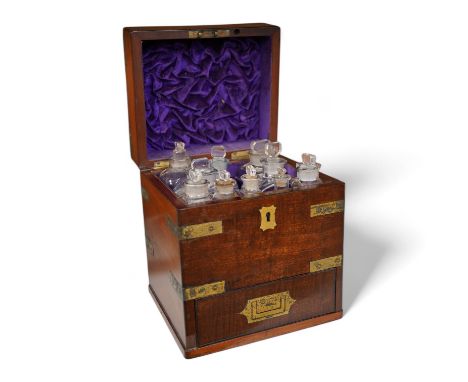 An early 19th century mahogany apothecary box, containing ten glass bottles, one with original paper label for the chemist El