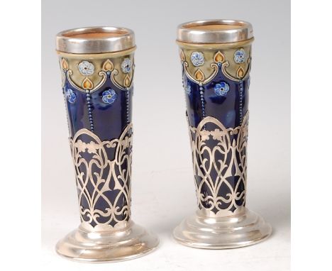 A pair of Royal Doulton Art Nouveau stoneware and silver pedestal specimen vases, each having silver rims, of circular taperi