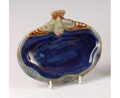 A Doulton Lambeth stoneware bibelot, modelled as a stylised swooping bird to wavy upper edge, underglaze painted, stamped mar