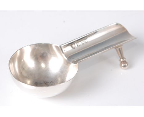 An early 20th century silver novelty cigar holder, in the form of a measuring spoon, with twin turned rear supports, maker Ha