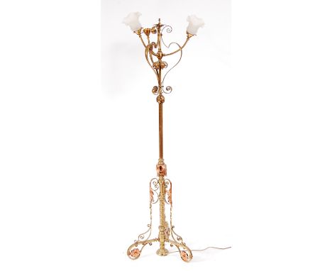 In the manner of W.A.S. Benson - a circa 1900 brass three light standard lamp, having stylised floral copper mounts and of al