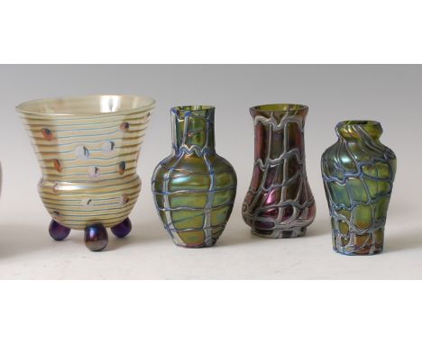An iridescent art glass vase, of circular tapering slightly lower bulbous form, on three bulbous feet, the body with concentr