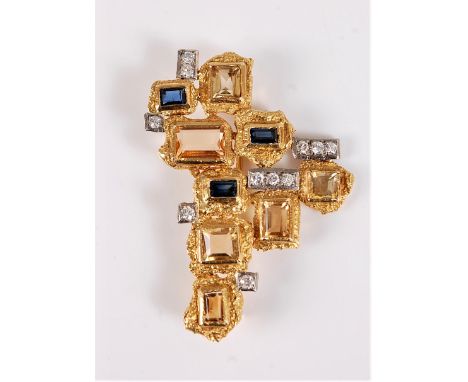 A gemset pendant/brooch by Charles de Temple, the asymmetric pendant/brooch set with step cut sapphires, topaz and citrines, 