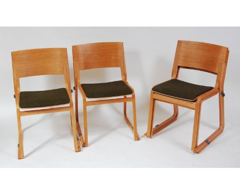 Chorus Furniture - a set of four Camira Blazer II light oak and plywood stacking chairs, each having green cloth fabric fixed