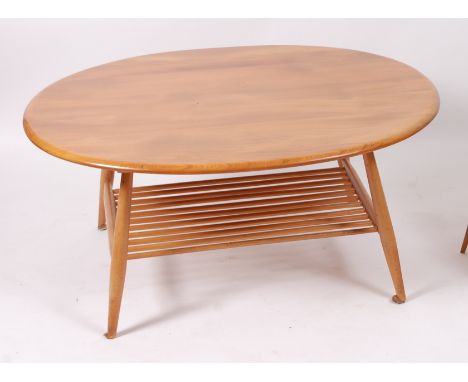 A 1960s Ercol blond elm oval low coffee table, having typical laddered undertier, h.45cm, w.99cm, d.82cm