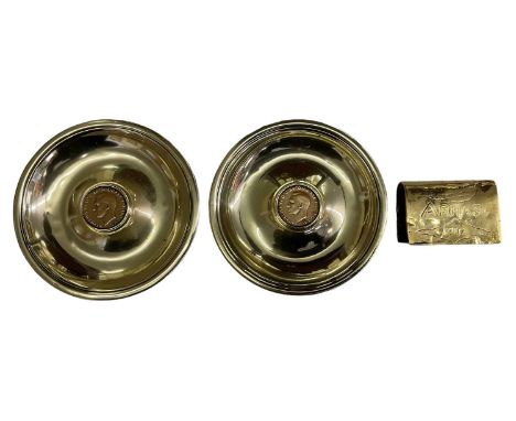 TRENCH ART; a pair of pin dishes, each set with 1937 pennies, diameter 12cm, and a brass matchbox holder incribed 'ARRAS, 191