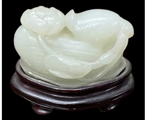 A Chinese jade modelled as a bird, on hardwood base, height 5cm, length 5.5cm.