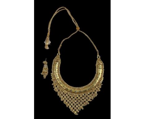 A yellow metal Pakistani wedding gift necklace, with gold drop tassels, and matching earring, combined approx 55g.Condition R