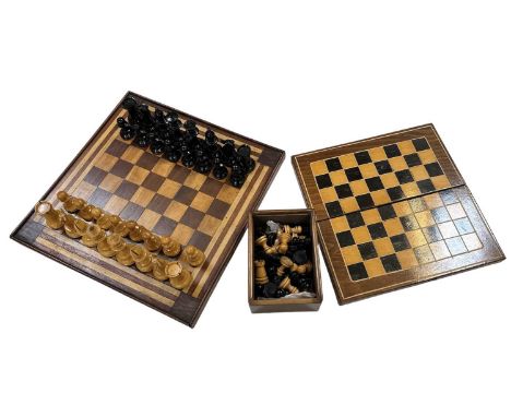 A cased Staunton chess set, another cased chess set, a games box and a chessboard, 39 x 39cm.