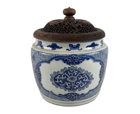 An 18th century Kangxi period blue and white decorated jar with carved hardwood cover, double ring mark to base, height 25cm,