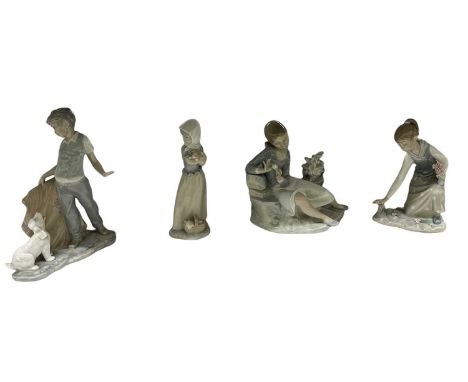 LLADRÓ; two porcelain figures of young girls, a Nao figure of a girl and a further Nao figure of a boy with a dog (4).