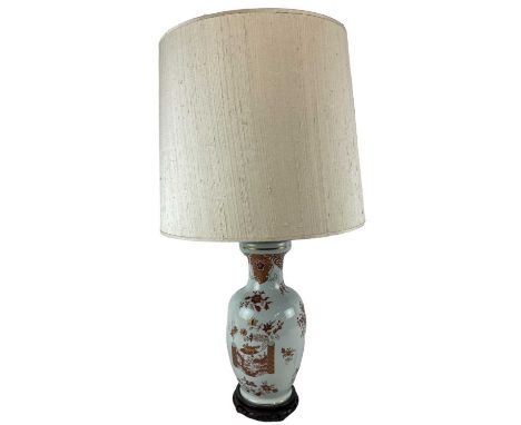 A modern Japanese porcelain floral decorated table lamp, on carved hardwood base, height to top of fitment 47cm.