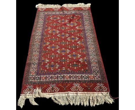 A modern red ground Turkmenistan Yamout hand knotted wool pile rug, 187 x 114cm.Provenance: This item was purchased from Self