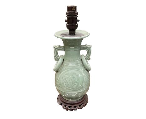 A Korean celadon glazed porcelain table lamp on carved hardwood base, height to top of fitment 32cm.