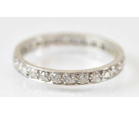 A white metal diamond set eternity ring, size R/S, approx 3.6g.