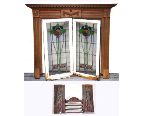 A modern carved pine fire surround and an unrelated cast iron fire insert and two leaded light windows (4).