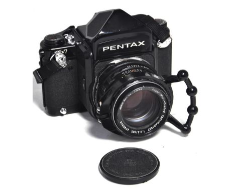 A Pentax 67 camera with 105mm lens, prism finder, quick focus ring, carry strap and hard lens case.   CONDITION REPORT Camera