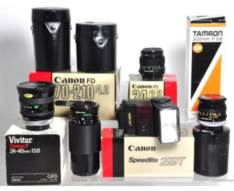 A collection of Canon fitting lenses to include a 24mm f2.8 wide angle lens, 70-210 zoom lens, a 50mm f1.8 standard lens, a V