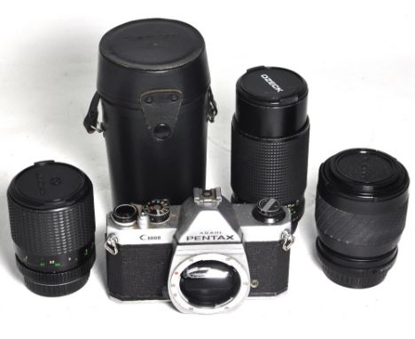 A Pentax K1000 SLR camera body only, a Tokina 70-210mm zoom lens, a Clubman 35-75mm zoom lens and an Ozeck 75-200mm zoom lens