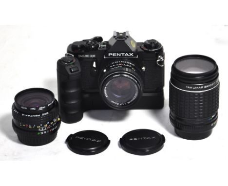 A Pentax ME Super 35mm SLR camera in black finish, a Takumar 135mm telephoto lens and a Pentax 28mm wide angle lens, power wi