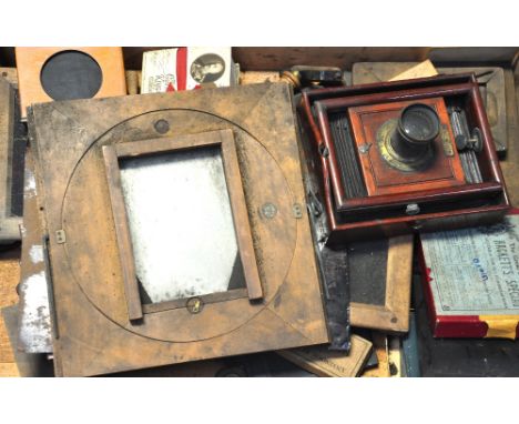 A late 19th century mahogany half plate camera bearing the makers mark for J.J. Atkinson Liverpool, fitted with a brass mount