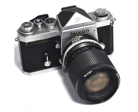 A Nikon F 35mm SLR camera with plain prism and  35-105mm Nikkor zoom lens. CONDITION REPORT Camera serial number 7347633, len