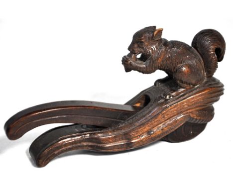A late Victorian novelty carved beech nutcracker modelled as a squirrel nibbling his nuts, length 22.5cm. CONDITION REPORT Th