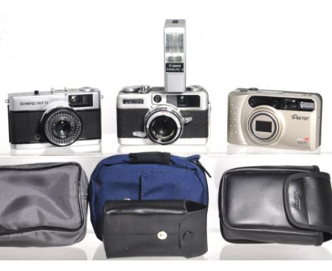 A Canon Demi-EE 17 half frame compact camera complete with dedicated Canolite Delectronic flash gun, an Olympus Trip 35 and a