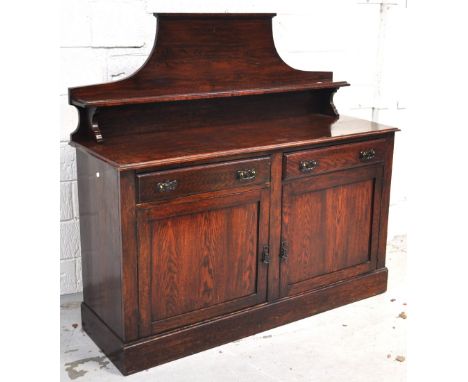 An early 20th century oak sideboard with shield shape back with shelf, two drawers over two cupboard doors, 137 x 145cm.