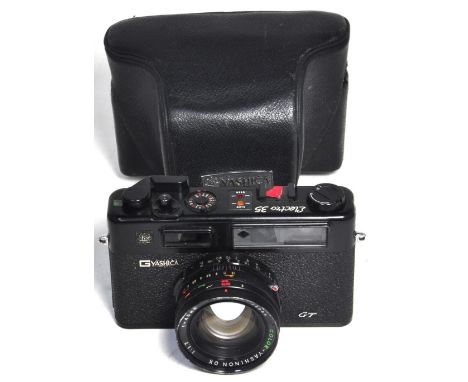 A Yashica Electro 35 rangefinder camera in black finish complete with ever-ready case. CONDITION REPORT A nice clean example 