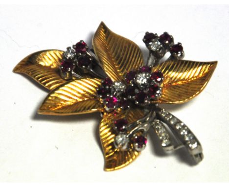 A yellow metal brooch in the form of a leaf set with ruby and diamond floral sprays, approx weight 16.7g, approx length 4cm.