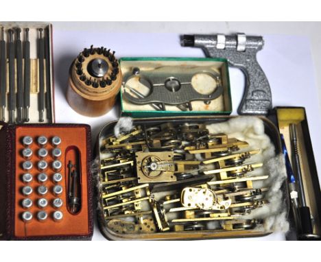 A quantity of watch makers tools to include drills, a hand remover, chamfers etc.