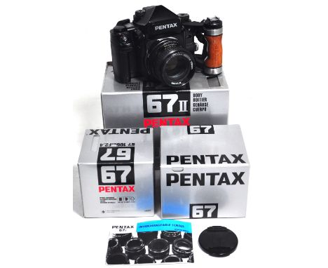 A Pentax 67 Mk.II camera with 105mm lens, AE finder, wooden hand grip and carrying strap, boxed. CONDITION REPORT Camera seri