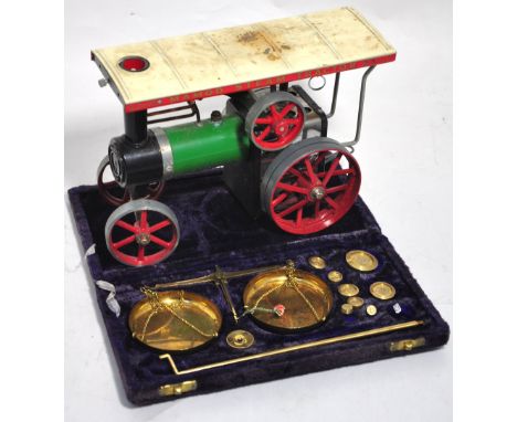 A boxed Mamod traction engine and a modern cased set of brass beam scales with weights weighing from 1g to 50g (2).