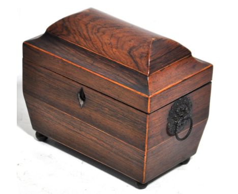 An early Victorian rosewood two division tea caddy of sarcophagus form, the hinged lid revealing two further lidded compartme