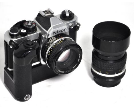 A Nikon FM2 35mm SLR camera complete with 50mm 1.8 standard lens, MD'12 motor drive unit and a Nikkor 85mm F2 telephoto lens 