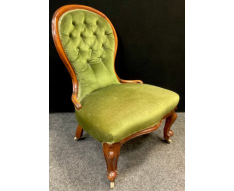 A Victorian walnut spoon-back nursing chair, button-back, upholstered back and seat, serpentine shaped front to seat, cabriol