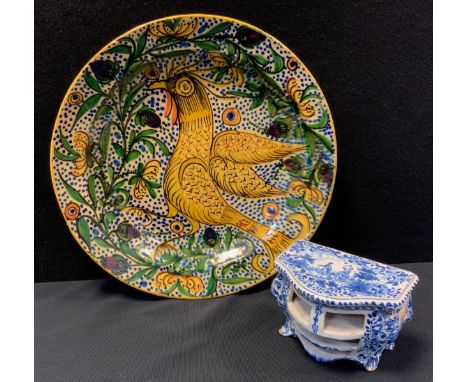 A continental Miaolica pottery dished charger, decorated with a cockerel standing, in tones of green, mustard yellow, blue an