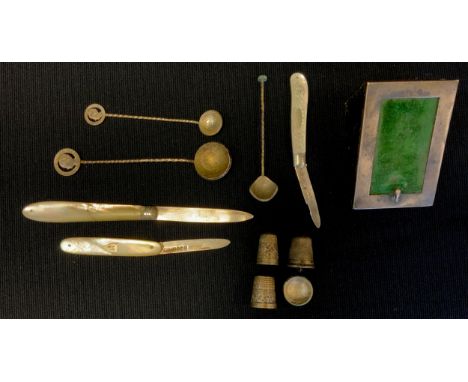 A Victorian silver mother of pearl handled folding fruit knife, Birmingham 1899;  others;  silver fronted watch stand; three 