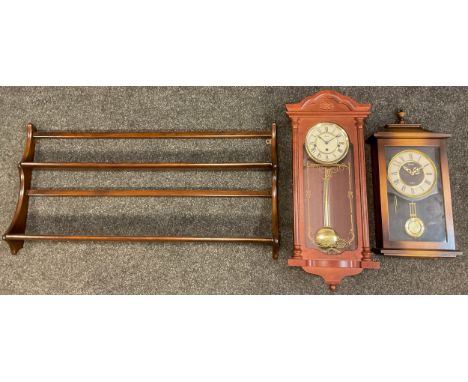 An Ercol Elm wall mounted plate rack, two tiers, 50cm high x 97cm;  a contemporary Hermle Vienna wall clock, 31-day chiming m