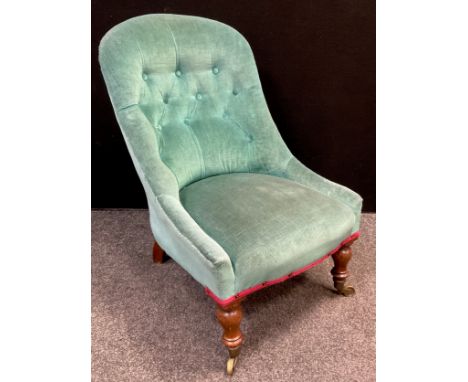 A Victorian walnut slipper / nursing chair, button-back, fully upholstered back and seat, turned legs, brass casters, 83cm hi