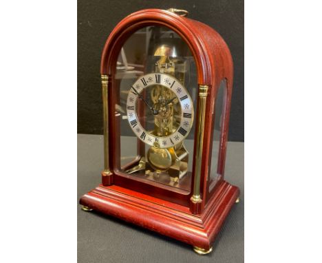 A  Hermle mahogany cased skeleton clock, domed case, silvered dial, Roman numerals, mechanical movement, 29cm high 