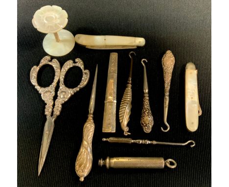 A Victorian silver folding fruit knife, Sheffield 1855;  similar button hook,  others silver hafted, scissors, needle case et