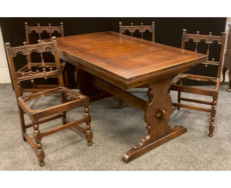 An Ercol dark Elm extending trestle dining table, and set of four conforming Elm chairs, ‘Old Colonial’ model, (table measuri